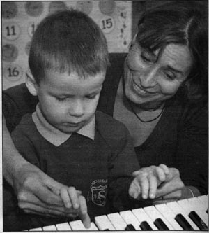 Elza Lusher gives Haden Stevens, four, his first piano lesson